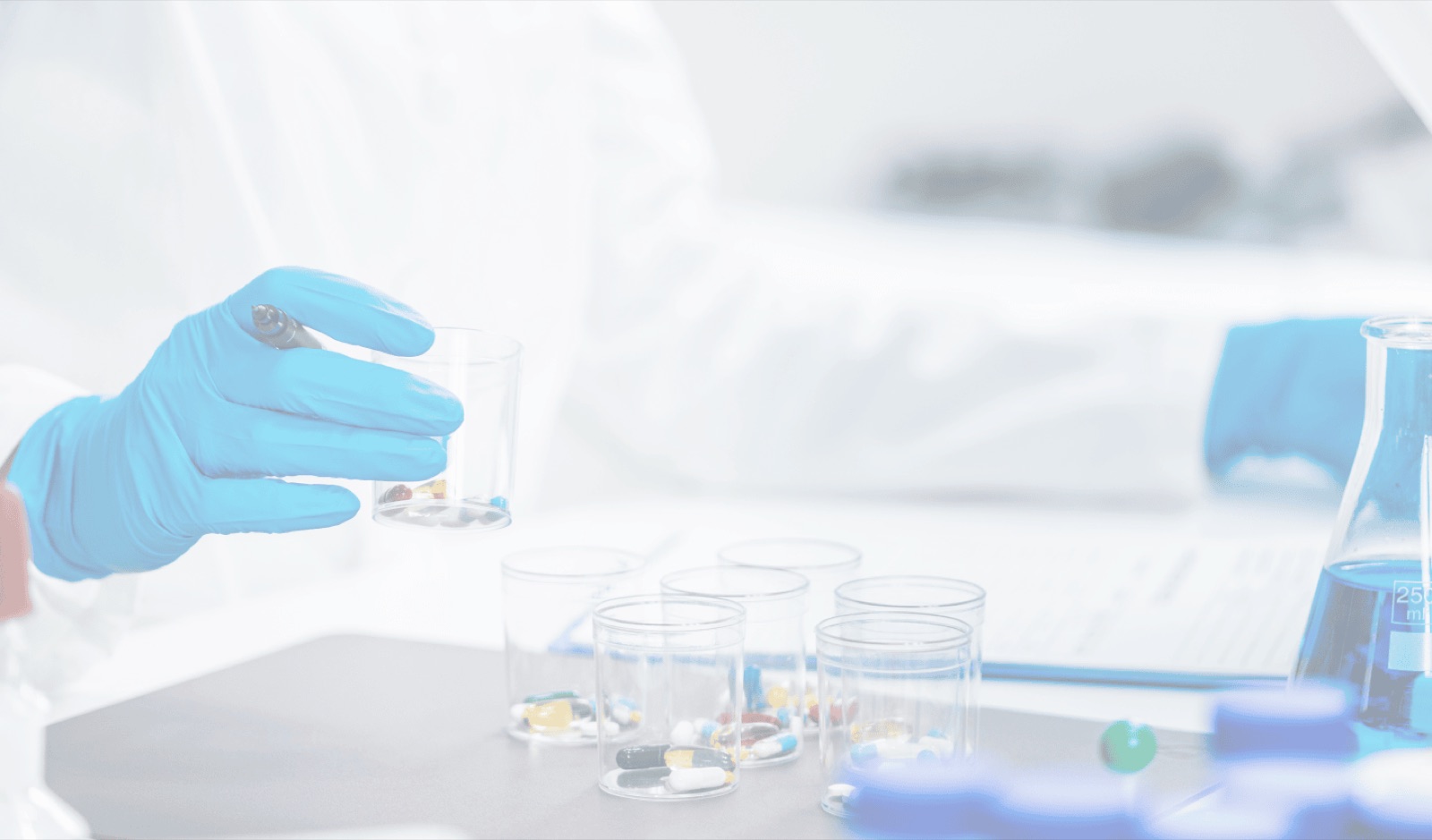 A compounding technician working with capsules in the lab